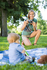 Image showing Woman Clicking Picture Of Baby Boy In Park