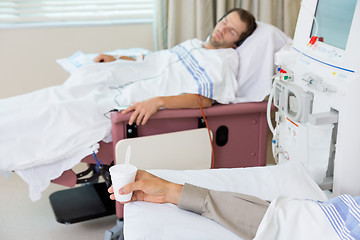 Image showing Patient Holding Glass Of Crushed Ice During Dialysis