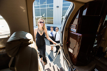 Image showing Beautiful Woman In Dress Boarding Private Plane