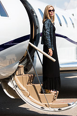 Image showing Wealthy Woman Stepping Out Of Private Plane