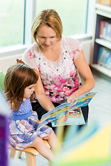 Image showing Teacher With Schoolgirl Reading Book