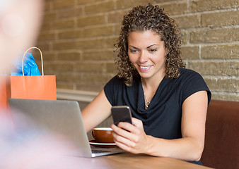 Image showing Woman Using Cell Phone in Cafe