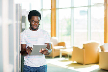 Image showing Smiling Student Using Digital Tablet At Library