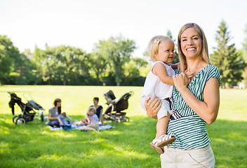 Image showing Happy Mother Carrying Daughter In Park