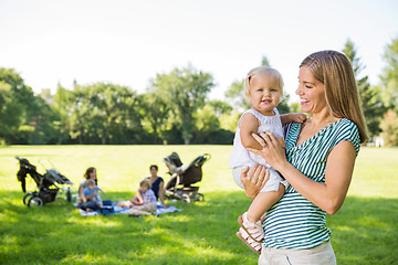 Image showing Mother Looking At Cute Daughter In Park