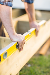 Image showing Carpenter's Hands Checking Level Of Wood