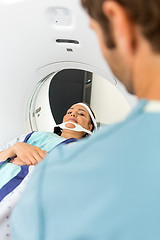 Image showing Patient Looking At Nurse While Undergoing CT Scan