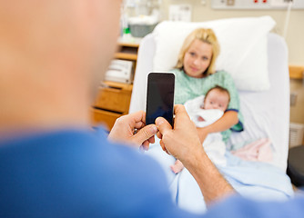 Image showing Man Photographing Woman And Babygirl Through Cell Phone