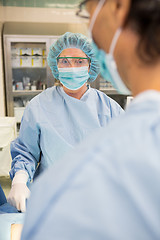 Image showing Doctor With Colleague Operating Patient