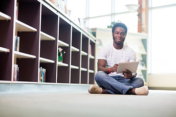 Image showing Male Student Using Digital Tablet In Library