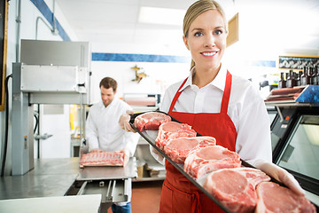 Image showing Happy Butcher Showing Meat Tray In Store