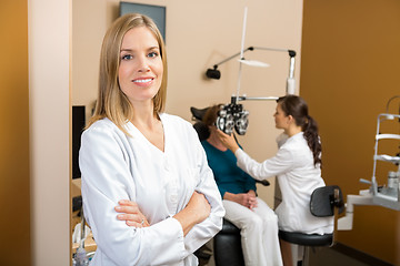 Image showing Confident Eye Doctor With Colleague Examining Patient