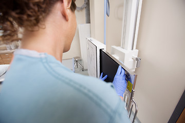 Image showing Female Nurse Adjusting Xray Film In Machine