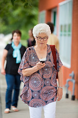 Image showing Woman Using Mobilephone On Pavement