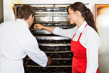 Image showing Workers Drying Meat In Oven At Butcher's Shop