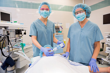 Image showing Nurses Adjusting Oxygen Mask On Female Patient