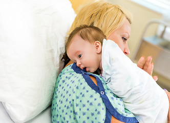 Image showing Babygirl Resting On Mother's Shoulder In Hospital