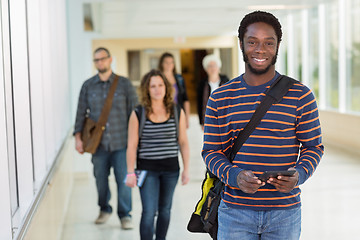 Image showing Portrait Of Student Holding Digital Tablet On University Corrido