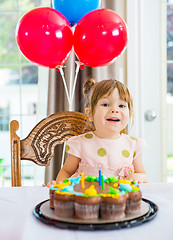 Image showing Girl Sitting In Front Of Cake At Home