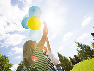 Image showing Mother And Daughter Playing With Balloons In Park