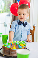 Image showing Boy Eating Birthday Cake