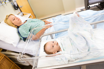 Image showing Babygirl Lying In Bassinet With Woman On Hospital Bed