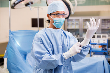 Image showing Surgeon Wearing Surgical Gloves In Operation Room