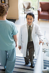 Image showing Doctor Climbing While Nurse Walking Down Stairs In Hospital