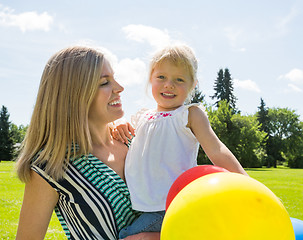 Image showing Mother And Daughter With Balloons In Park