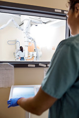 Image showing Nurse Operating Machine In Control Room