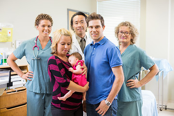 Image showing Medical Team With Newborn Baby Girl And Parents In Hospital