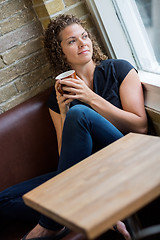 Image showing Woman Looking Through Window In Cafeteria