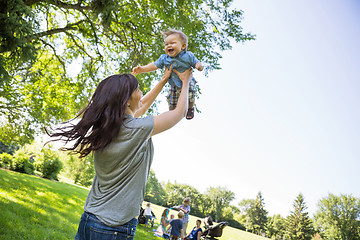 Image showing Playful Young Mother Lifting Baby Boy At Park