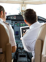 Image showing Pilot And Copilot Using Digital Tablet In Cockpit