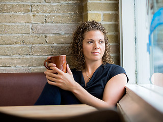 Image showing Woman Looking Through Window At Cafeteria
