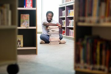Image showing Student With Books And Digital Tablet Sitting In Library