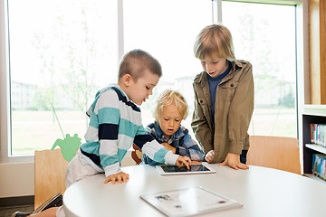 Image showing Boys Using Digital Tablet In Library