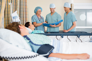 Image showing Nurses Examining Patient's Report