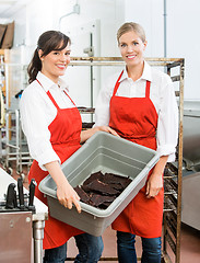 Image showing Beautiful Workers Carrying Beef Jerky In Basket At Shop