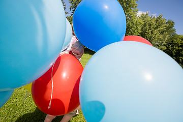 Image showing Boy Holding Balloons In Park