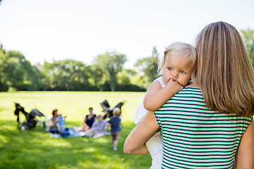 Image showing Mother Carrying Daughter Looking Away In Park