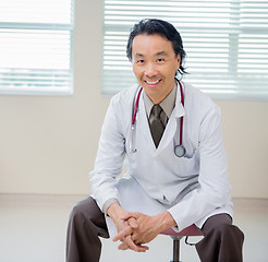 Image showing Portrait Of Happy Doctor Sitting In Hospital Room