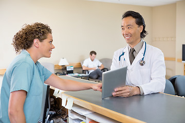 Image showing Doctor And Nurse Using Digital Tablet At Hospital Reception
