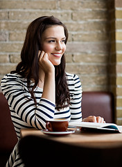 Image showing Woman With Hand On Chin Looking Away In Cafeteria