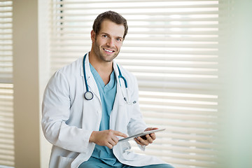 Image showing Happy Cancer Specialist Holding Digital Tablet At Clinic