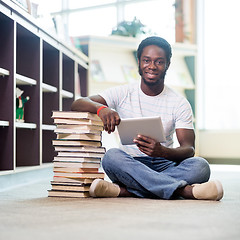 Image showing Student With Books And Digital Tablet Sitting In Library