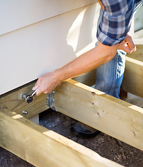 Image showing Carpenter's Hand Tightening Bolt With Wrench