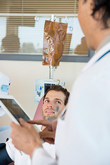 Image showing Patient Looking At Doctor Holding Digital Tablet In Chemo Room