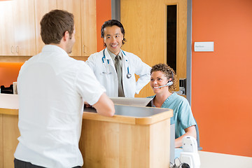 Image showing Medical Team With Patient At Reception Desk