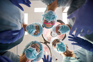 Image showing Multiethnic Medical Team With Masks And Scrubs In Operation Room